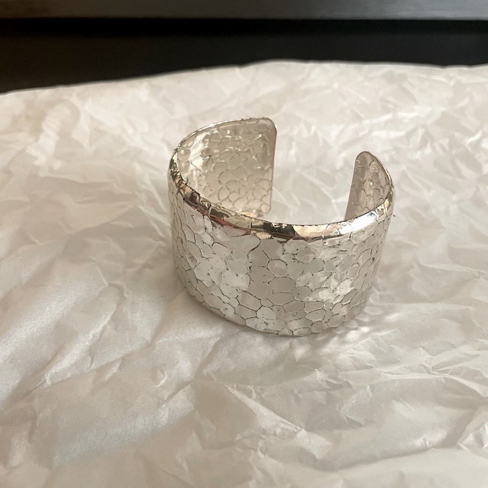 Silver, adjustable cuff bracelet.